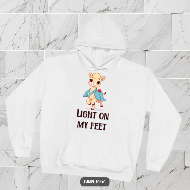 Funny hoodie showing a bright-eyed camel in a blue kimono, prancing lightly, offering warm and humorous desert vibes.